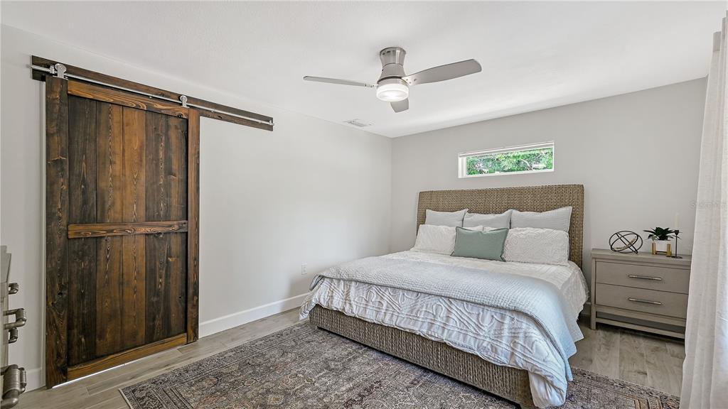 2115 Grove Street Sarasota, FL 34239 - Photo 18 of 40 a bedroom with a bed dresser and a window