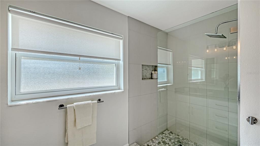 2115 Grove Street Sarasota, FL 34239 - Photo 22 of 40 a bathroom with a glass shower door
