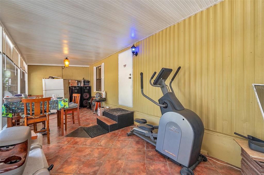 8844 Mike Street Port Richey, FL 34668 - Photo 17 of 51 a room with gym equipment and windows