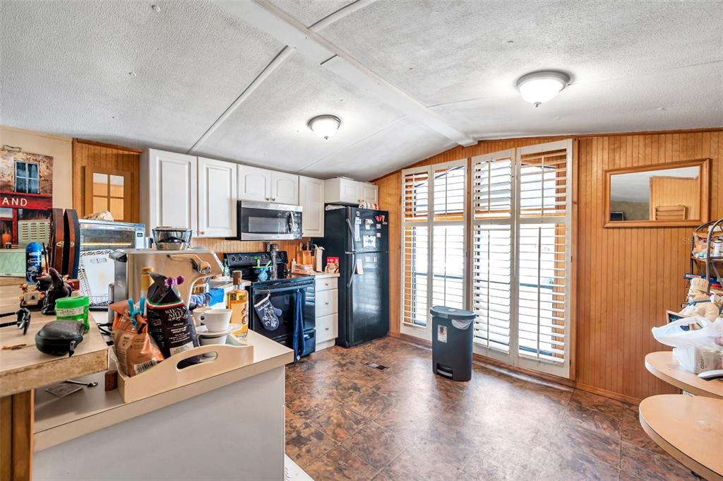 8844 Mike Street Port Richey, FL 34668 - Photo 18 of 51 a view of a kitchen with refrigerator and window