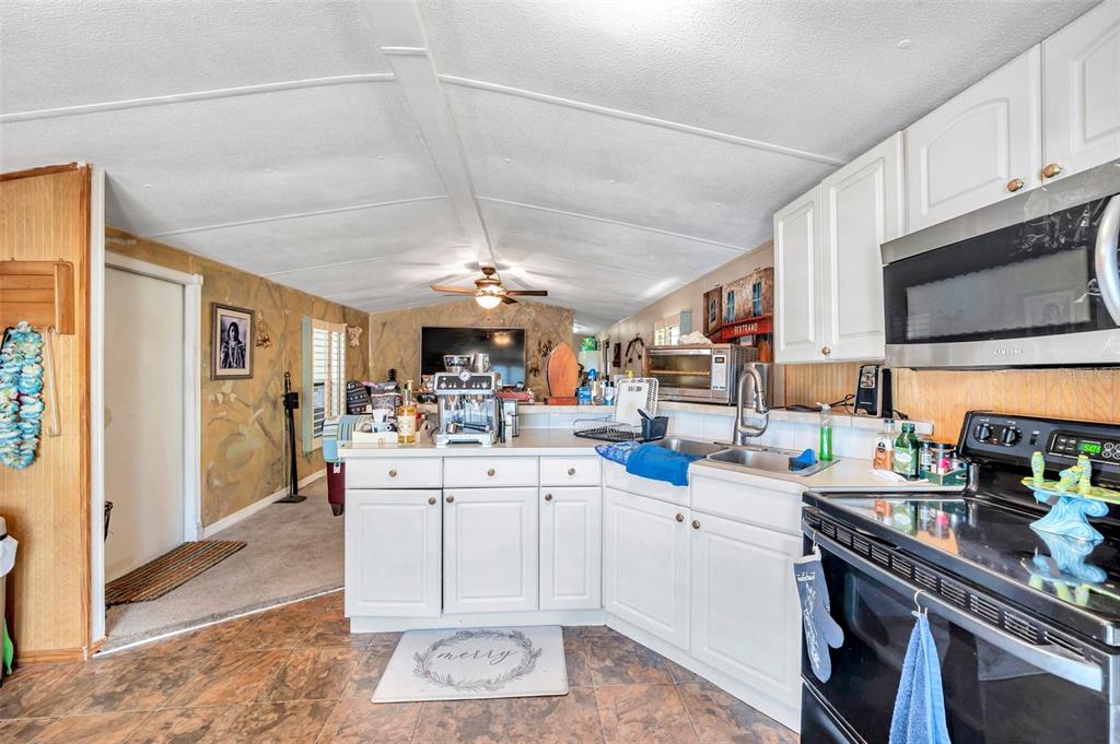 8844 Mike Street Port Richey, FL 34668 - Photo 20 of 51 a kitchen with a sink stove and cabinets