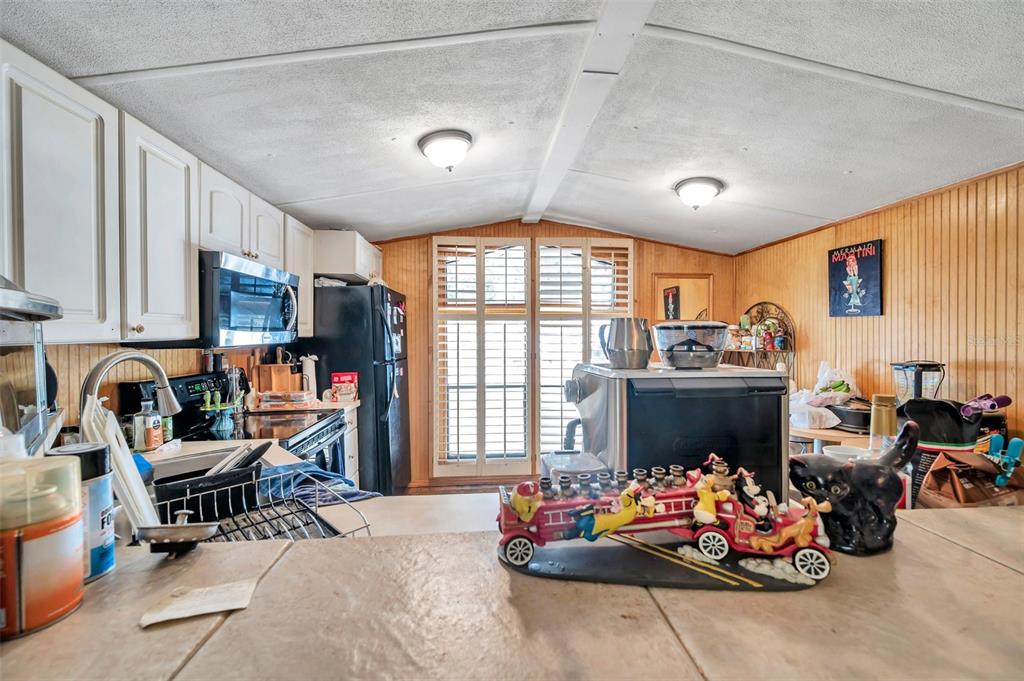 8844 Mike Street Port Richey, FL 34668 - Photo 21 of 51 a living room with furniture toys and a large window