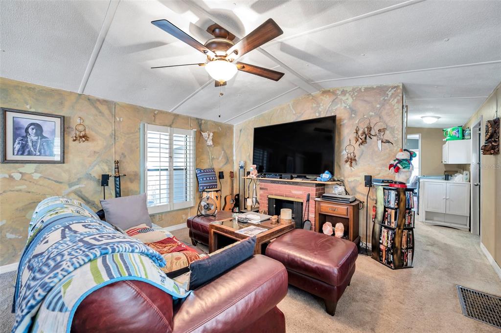 8844 Mike Street Port Richey, FL 34668 - Photo 22 of 51 a living room with furniture and a flat screen tv