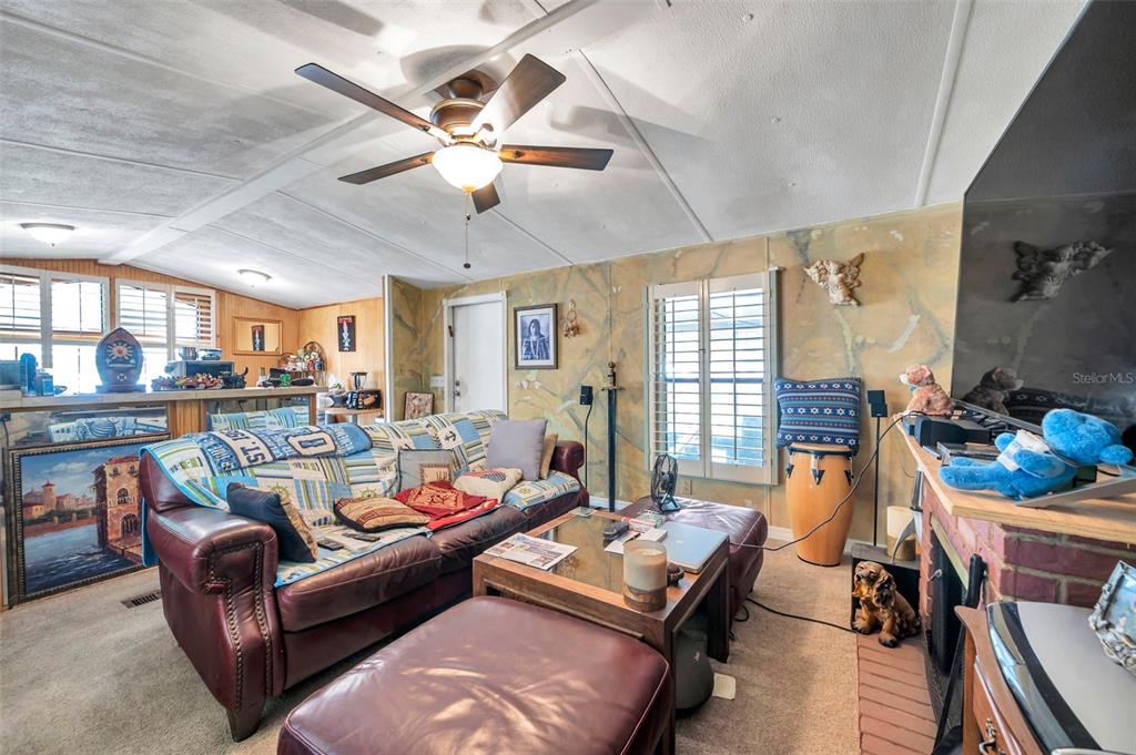 8844 Mike Street Port Richey, FL 34668 - Photo 24 of 51 a living room with furniture and wooden floor