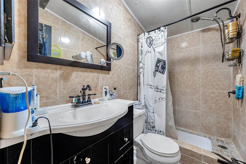8844 Mike Street Port Richey, FL 34668 - Photo 26 of 51 a bathroom with a sink a toilet and shower