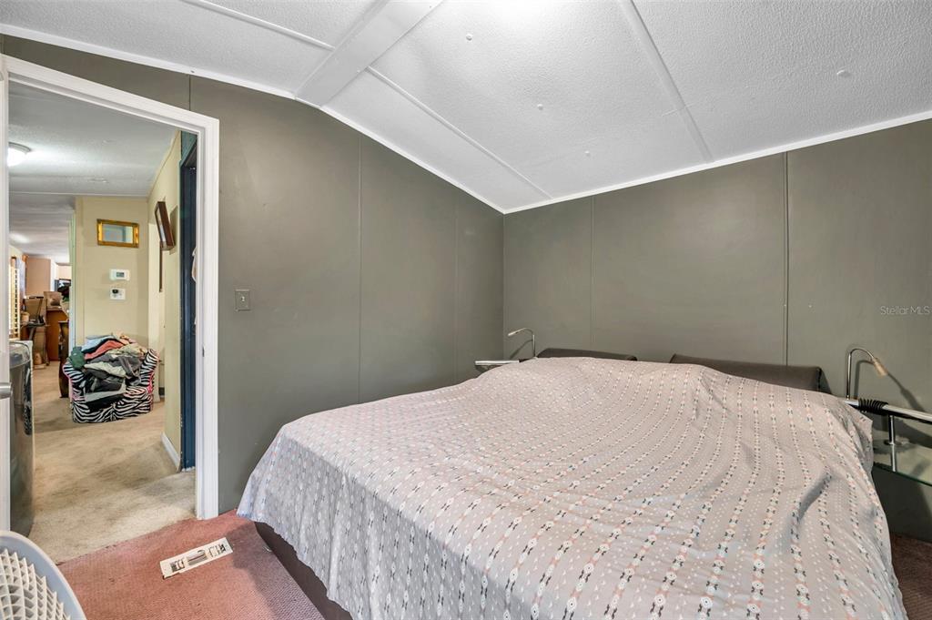 8844 Mike Street Port Richey, FL 34668 - Photo 29 of 51 a bedroom with a bed and view of bathroom