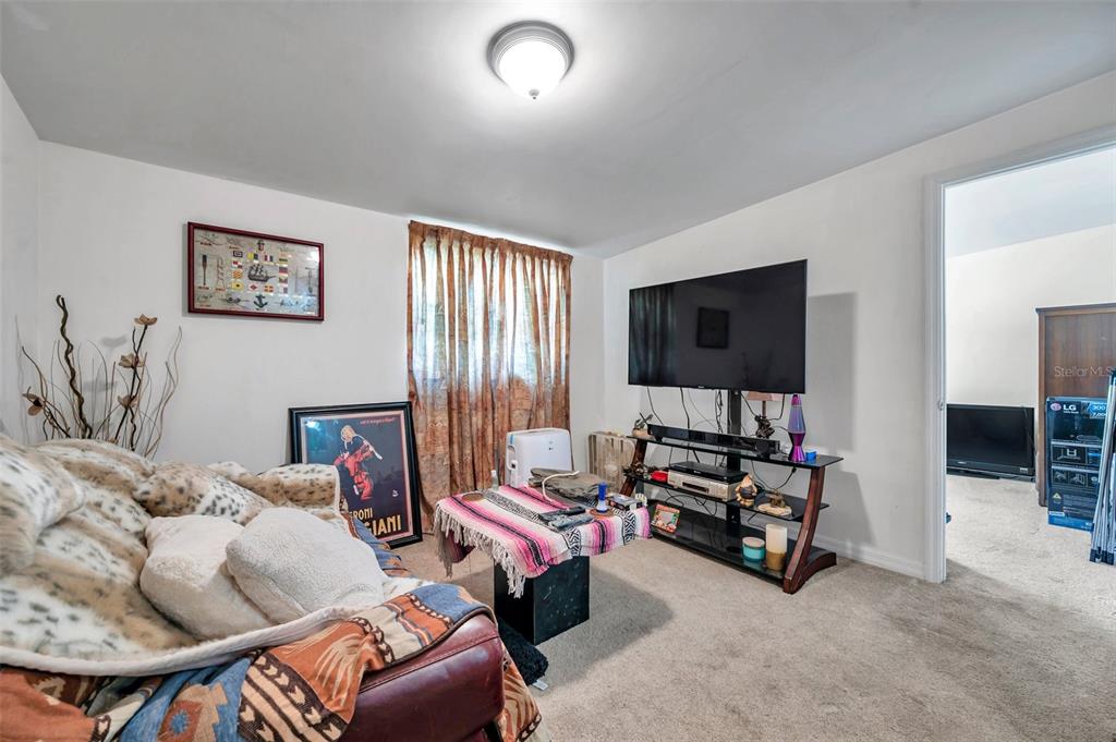 8844 Mike Street Port Richey, FL 34668 - Photo 31 of 51 a living room with furniture and a flat screen tv