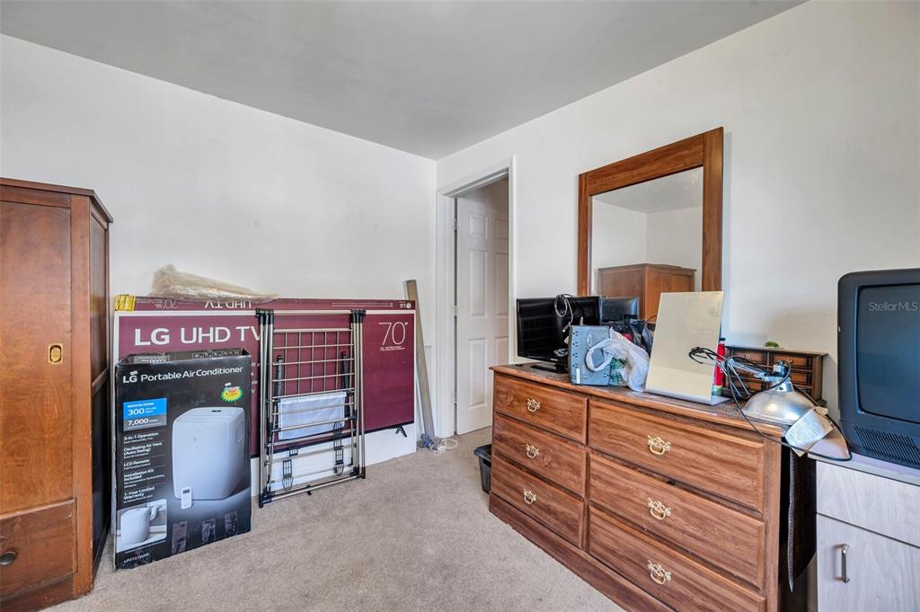 8844 Mike Street Port Richey, FL 34668 - Photo 35 of 51 a room with furniture and storage area