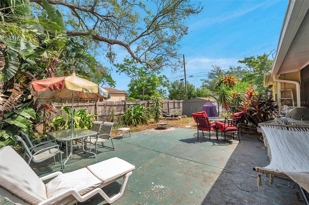 8844 Mike Street Port Richey, FL 34668 - Photo 7 of 51 a view of a backyard with a patio and outdoor seating