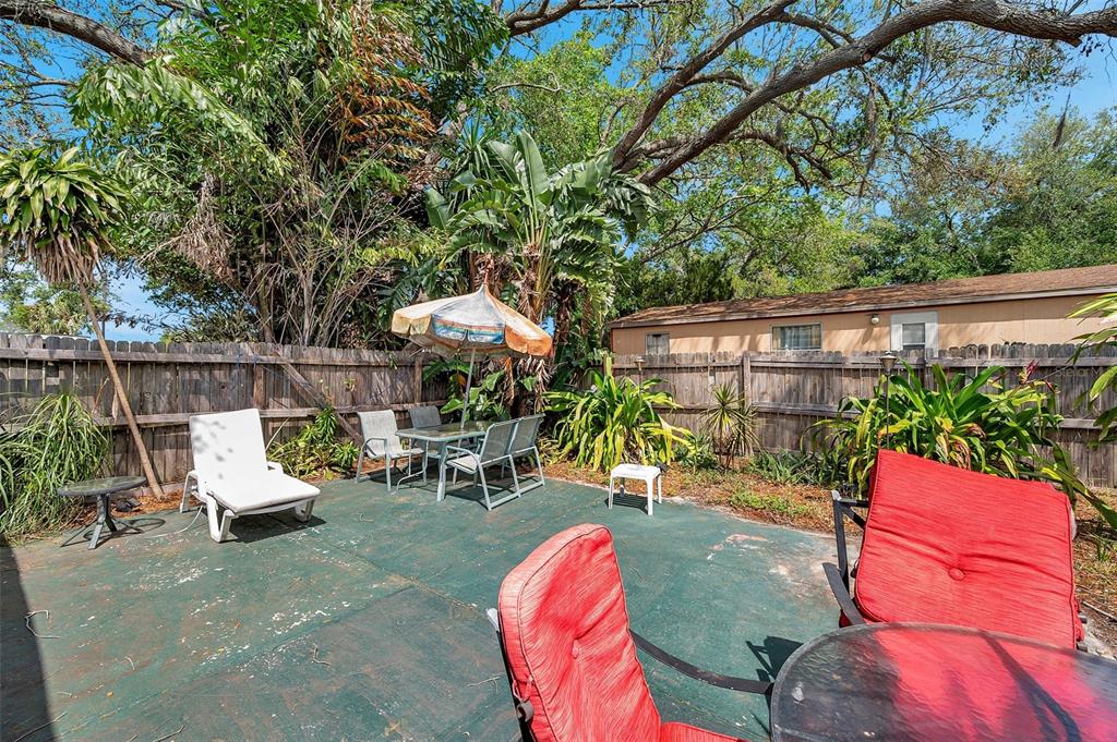 8844 Mike Street Port Richey, FL 34668 - Photo 8 of 51 an outdoor sitting area with couch and wooden fence