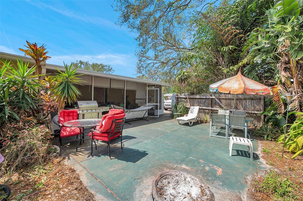 8844 Mike Street Port Richey, FL 34668 - Photo 9 of 51 a view of a backyard with table and chairs and potted plants