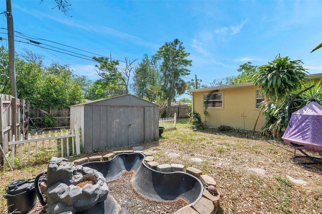 8844 Mike Street Port Richey, FL 34668 - Photo 10 of 51 a backyard of a house with yard and outdoor seating