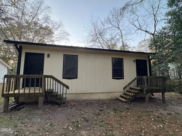 a backyard of a house with table and chairs