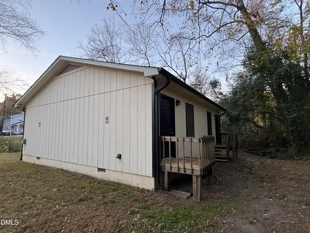 a backyard of a house with table and chairs