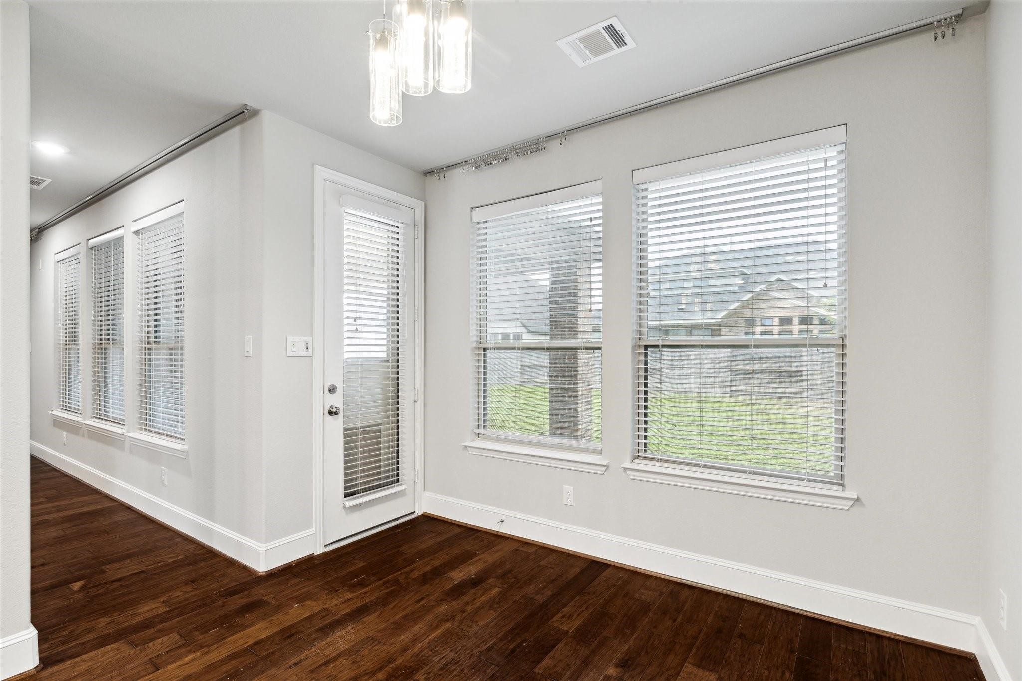 1010 Bat Hawk Court Conroe, TX 77385 - Photo 18 of 50 a view of an empty room with wooden floor and a window