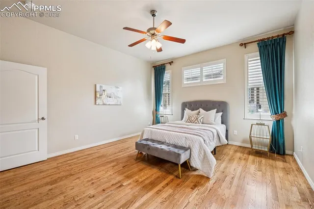 a spacious bedroom with a bed and a ceiling fan