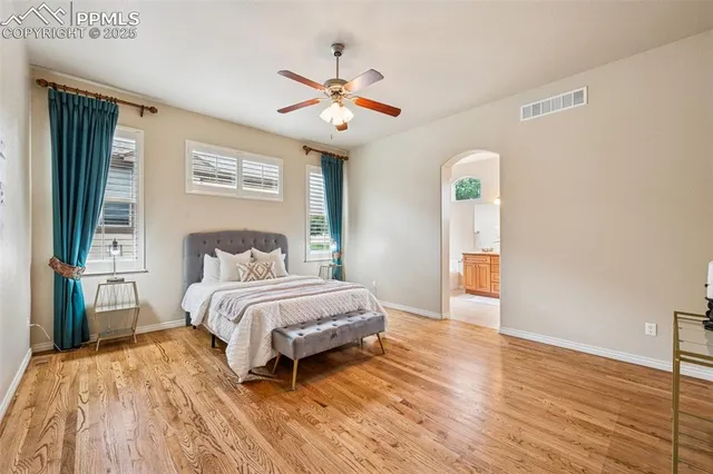 a spacious bedroom with a bed and a window
