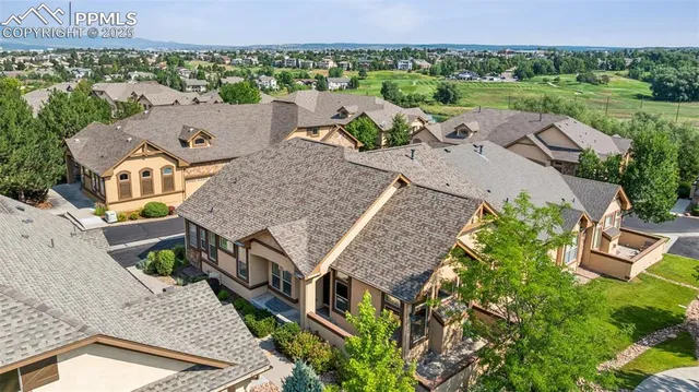 an aerial view of a house with a garden and lake view