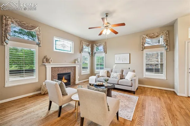 a living room with furniture a fireplace and wooden floor