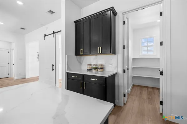 a bathroom with a sink vanity granite tub shower and closet