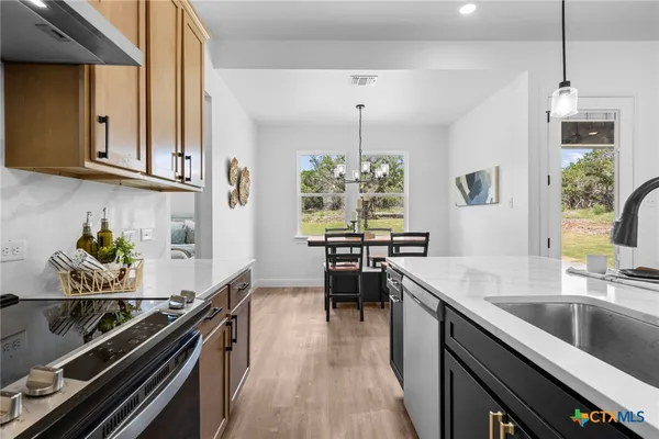 a kitchen with granite countertop lots of counter top space and stainless steel appliances