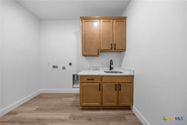a view of bathroom with a sink and a mirror