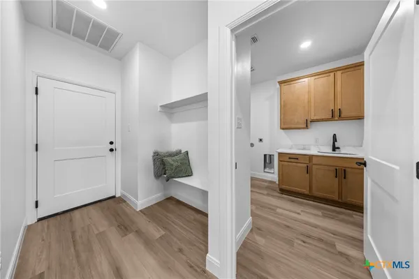 a view of a kitchen cabinets a sink and wooden floor