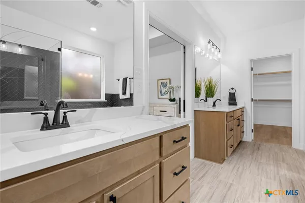 a bathroom with a sink double vanity and a mirror