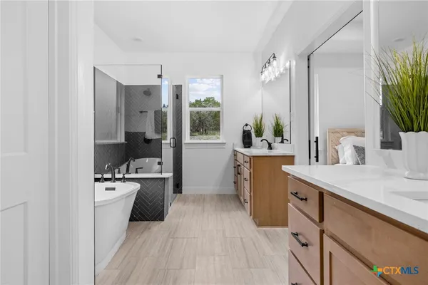 a bathroom with a sink a large mirror and a shower