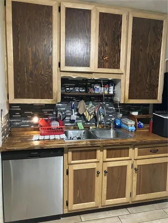 a kitchen with a sink cabinets and window