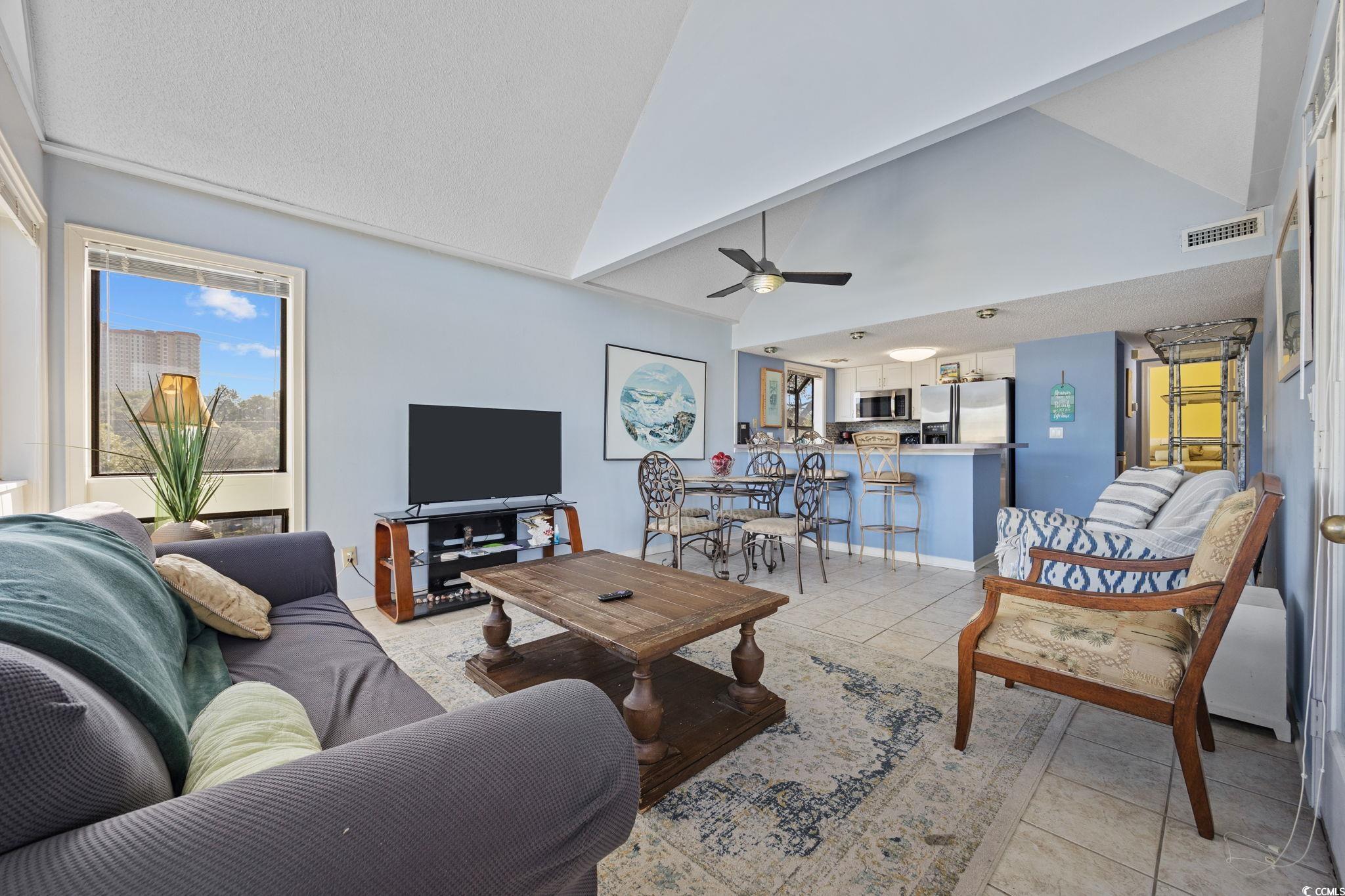 351 Lake Arrowhead Road, Unit 1301 Myrtle Beach, SC 29572 - Photo 12 of 40 Living area featuring light tile patterned floors, high vaulted ceiling, ceiling fan, and healthy amount of natural light