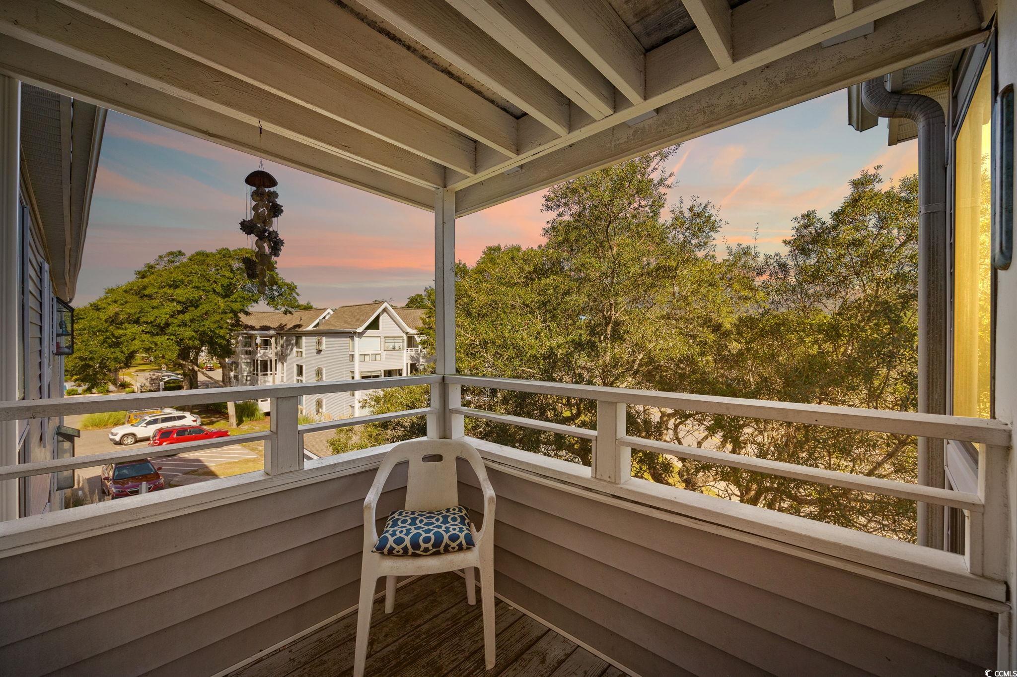 351 Lake Arrowhead Road, Unit 1301 Myrtle Beach, SC 29572 - Photo 15 of 40 Balcony at dusk featuring a sunroom