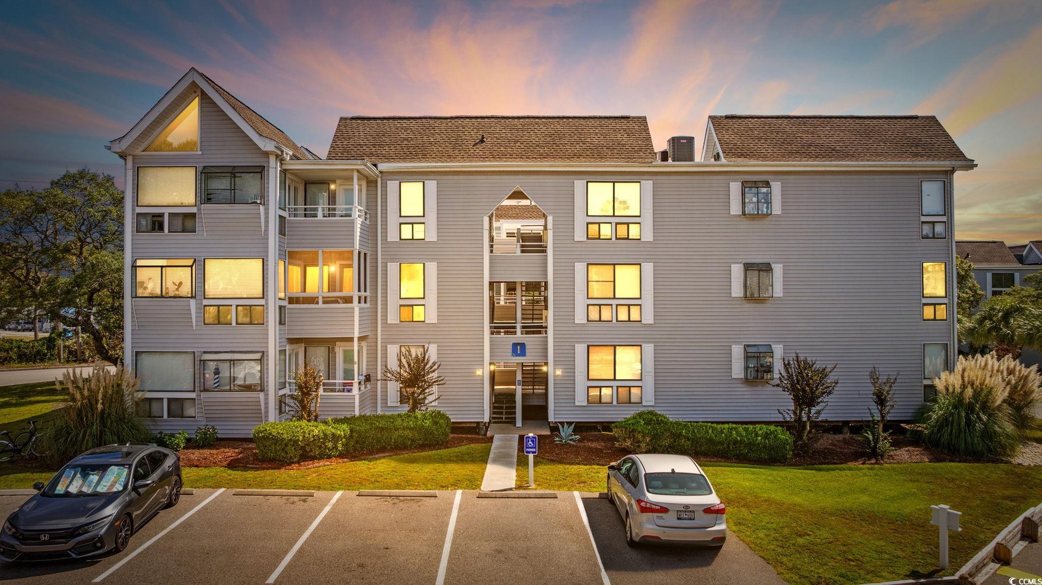 351 Lake Arrowhead Road, Unit 1301 Myrtle Beach, SC 29572 - Photo 39 of 40 Property at dusk with uncovered parking