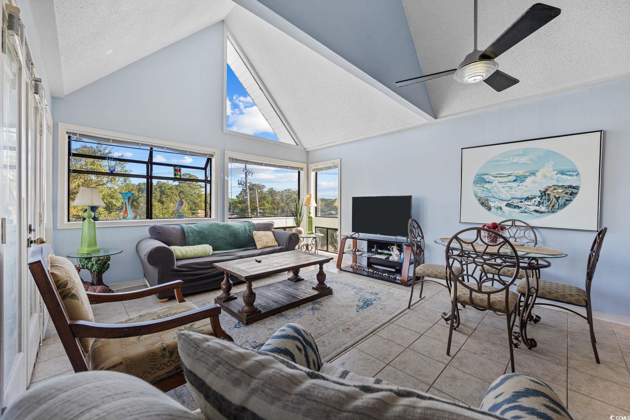 351 Lake Arrowhead Road, Unit 1301 Myrtle Beach, SC 29572 - Photo 7 of 40 Tiled living area featuring a textured ceiling, high vaulted ceiling, and ceiling fan