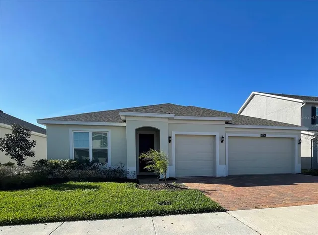 a front view of a house with a yard and garage