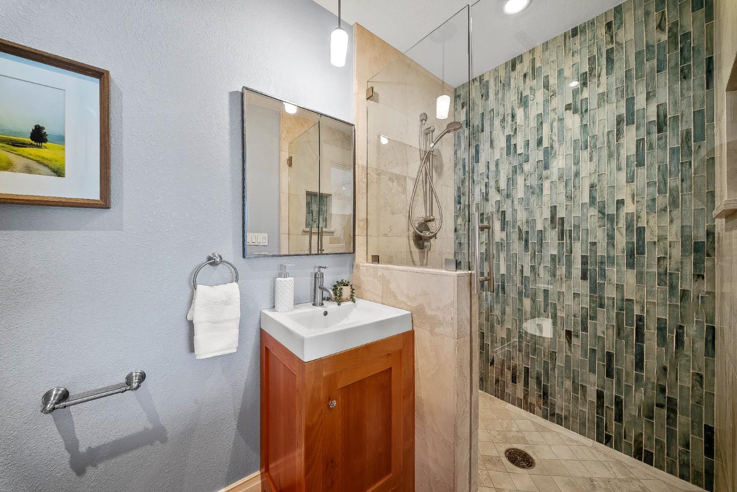 431 Canon Del Sol Watsonville, CA 95076 - Photo 18 of 50 a bathroom with a sink a mirror a vanity and shower