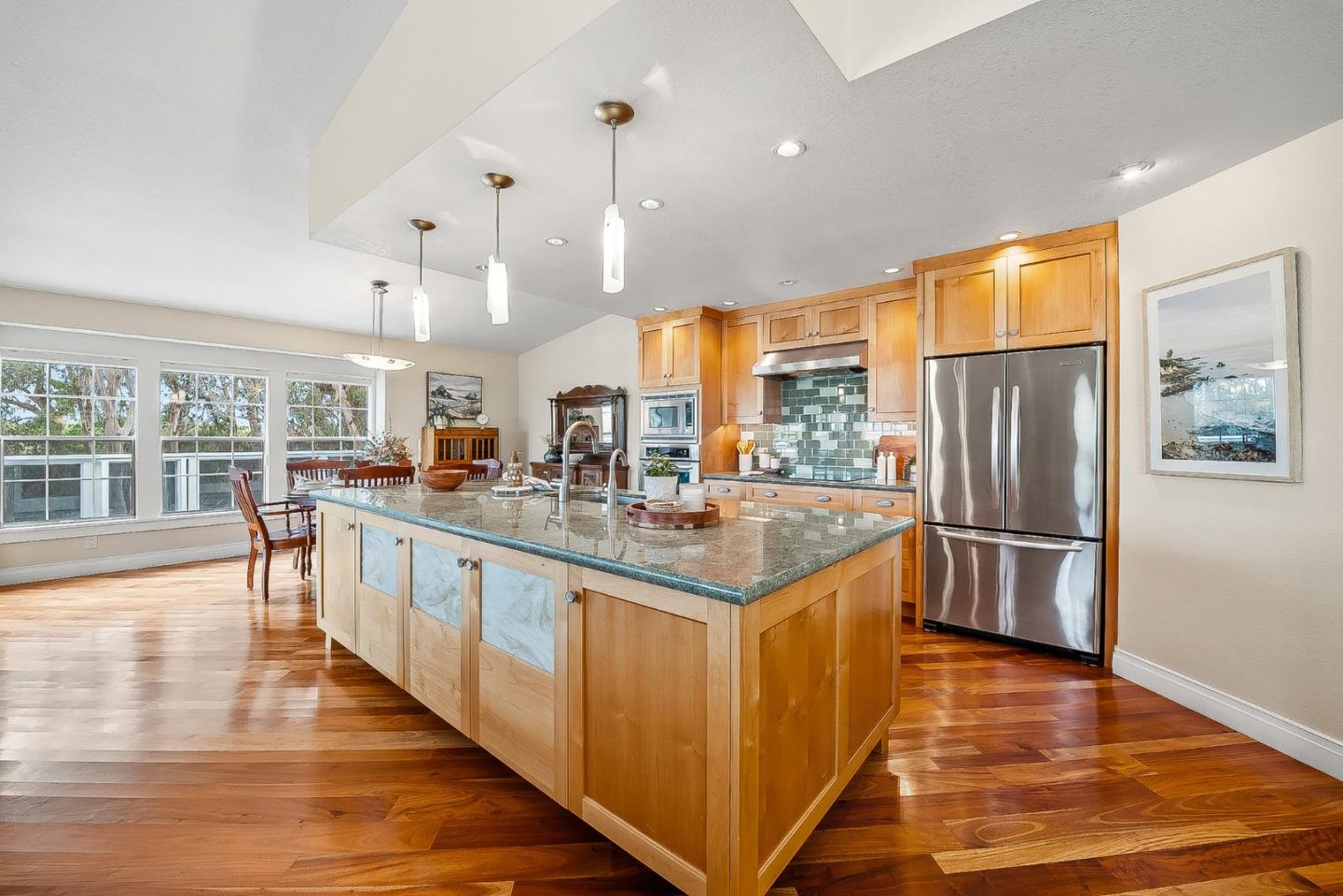 431 Canon Del Sol Watsonville, CA 95076 - Photo 8 of 50 a kitchen with stainless steel appliances granite countertop a refrigerator a sink and a stove with wooden floor