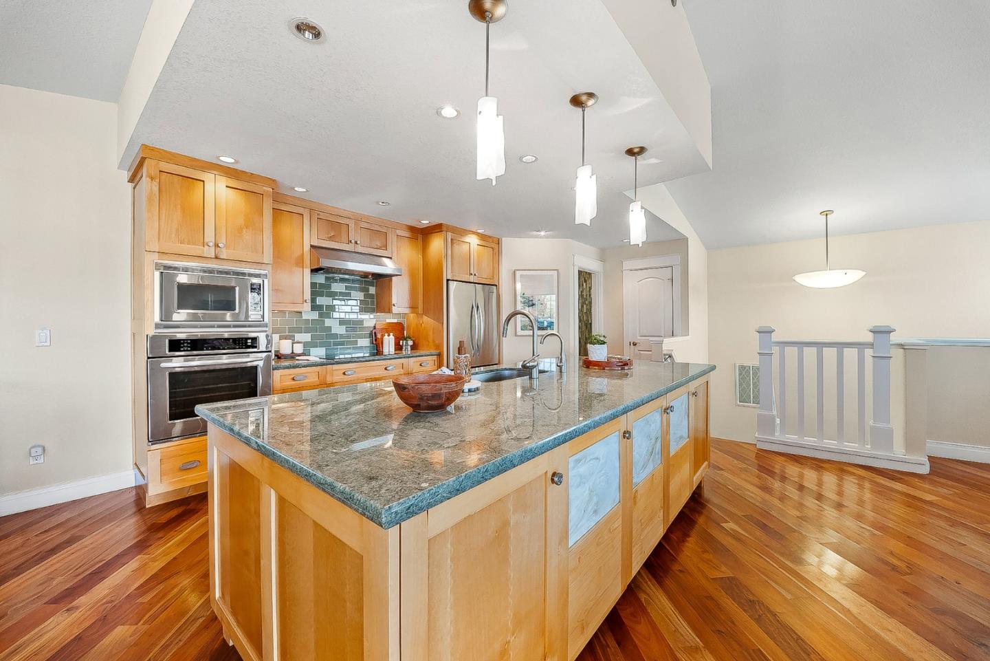 431 Canon Del Sol Watsonville, CA 95076 - Photo 9 of 50 a kitchen with stainless steel appliances granite countertop a sink a stove and a wooden floors