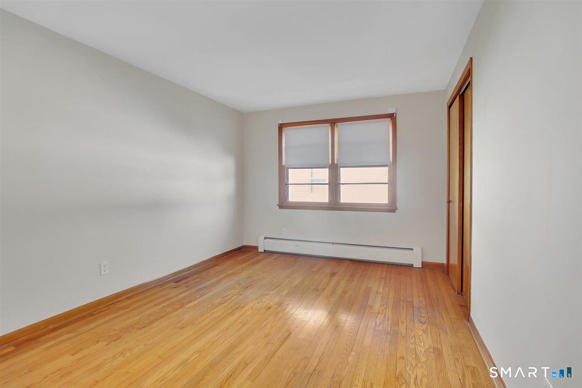 57 Alanby Drive Meriden, CT 06451 - Photo 11 of 20 an empty room with wooden floor and windows