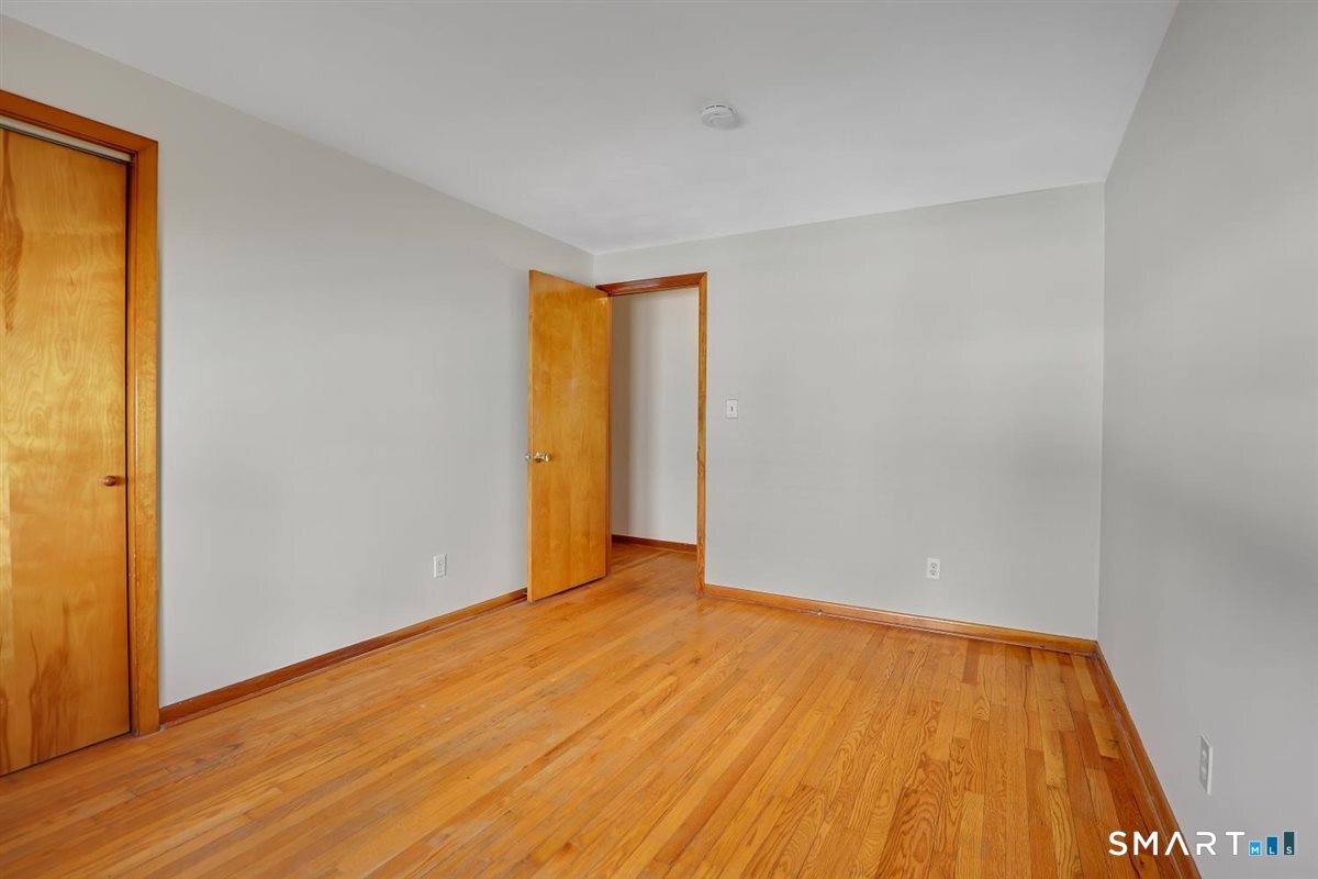 57 Alanby Drive Meriden, CT 06451 - Photo 12 of 20 a view of an empty room with wooden floor and a window