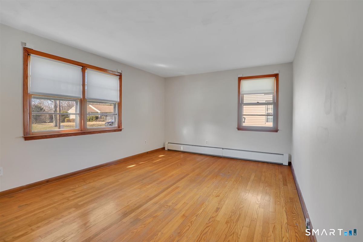 57 Alanby Drive Meriden, CT 06451 - Photo 13 of 20 a view of an empty room with wooden floor and a window