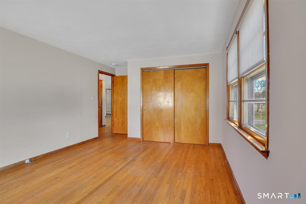 57 Alanby Drive Meriden, CT 06451 - Photo 14 of 20 a view of an empty room with wooden floor and a window