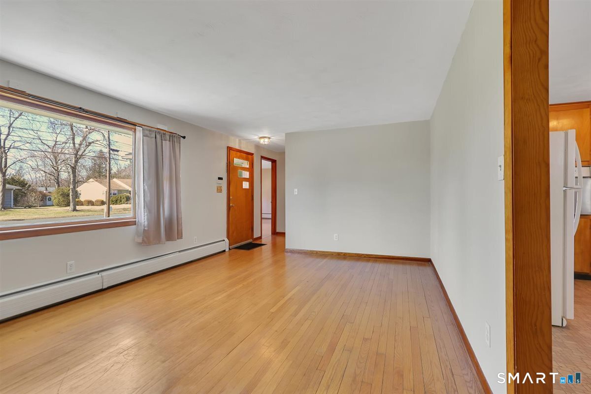57 Alanby Drive Meriden, CT 06451 - Photo 2 of 20 an empty room with wooden floor and windows