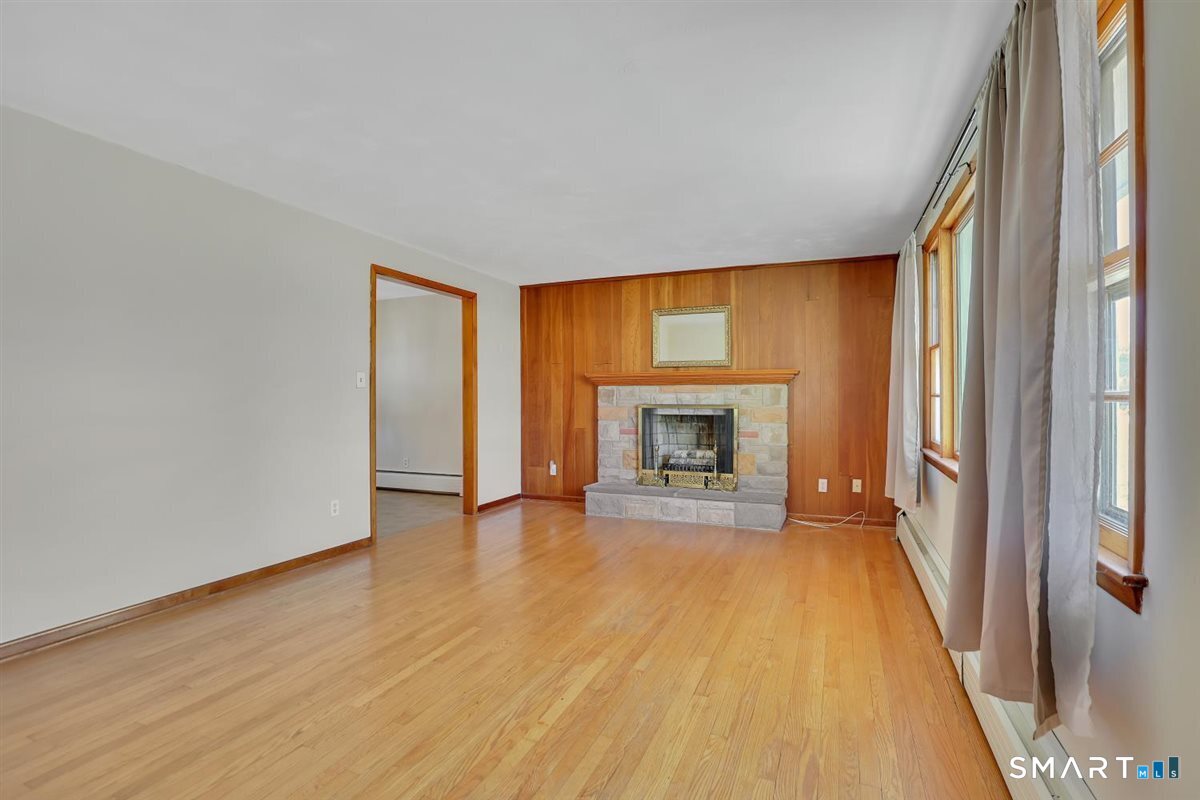 57 Alanby Drive Meriden, CT 06451 - Photo 3 of 20 a view of an empty room with a fireplace and a window