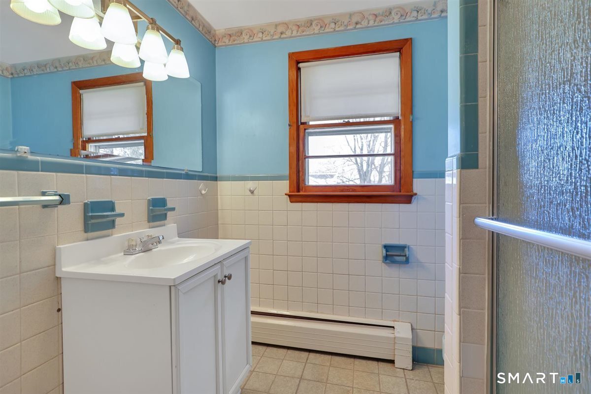 57 Alanby Drive Meriden, CT 06451 - Photo 8 of 20 a bathroom with a sink a mirror and a shower