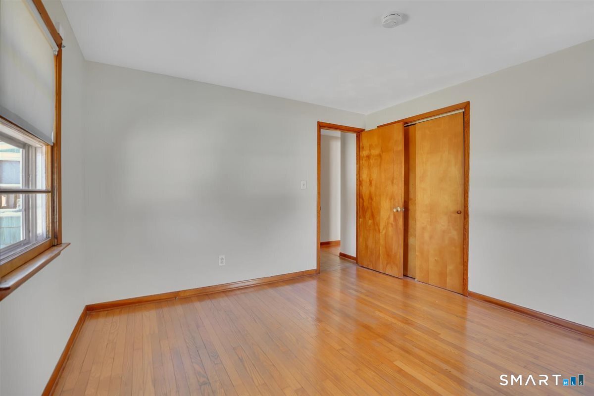 57 Alanby Drive Meriden, CT 06451 - Photo 10 of 20 a view of an empty room with wooden floor and a window