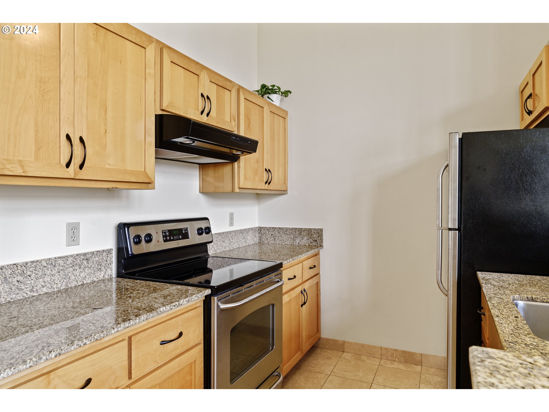 650 West 12th Avenue, Unit 202 Eugene, OR 97402 - Photo 12 of 30 a kitchen with stainless steel appliances granite countertop a refrigerator and a stove