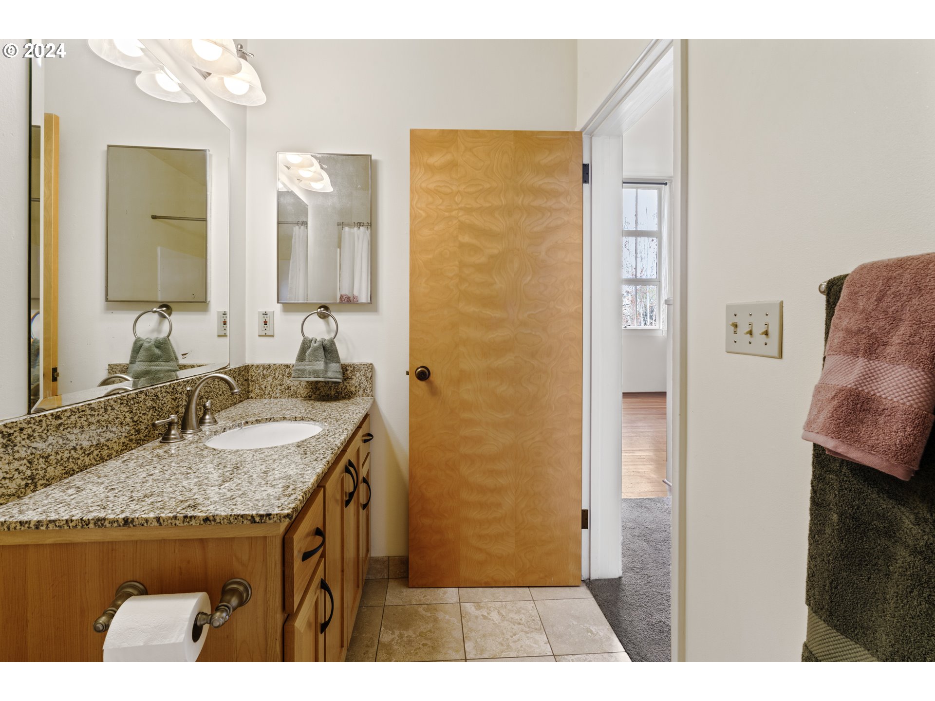 650 West 12th Avenue, Unit 202 Eugene, OR 97402 - Photo 17 of 30 a bathroom with a granite countertop sink and a mirror