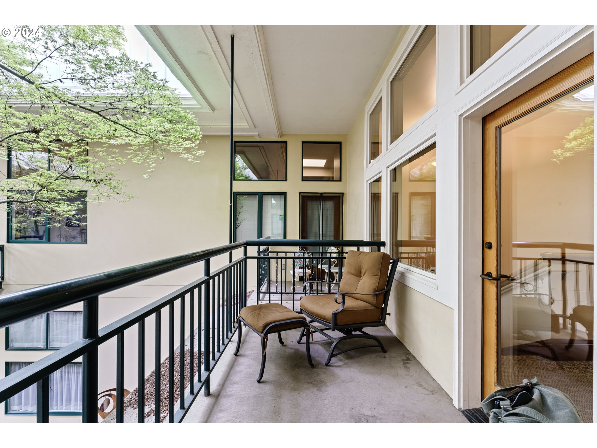 650 West 12th Avenue, Unit 202 Eugene, OR 97402 - Photo 21 of 30 a balcony with couple of chairs and a potted plant