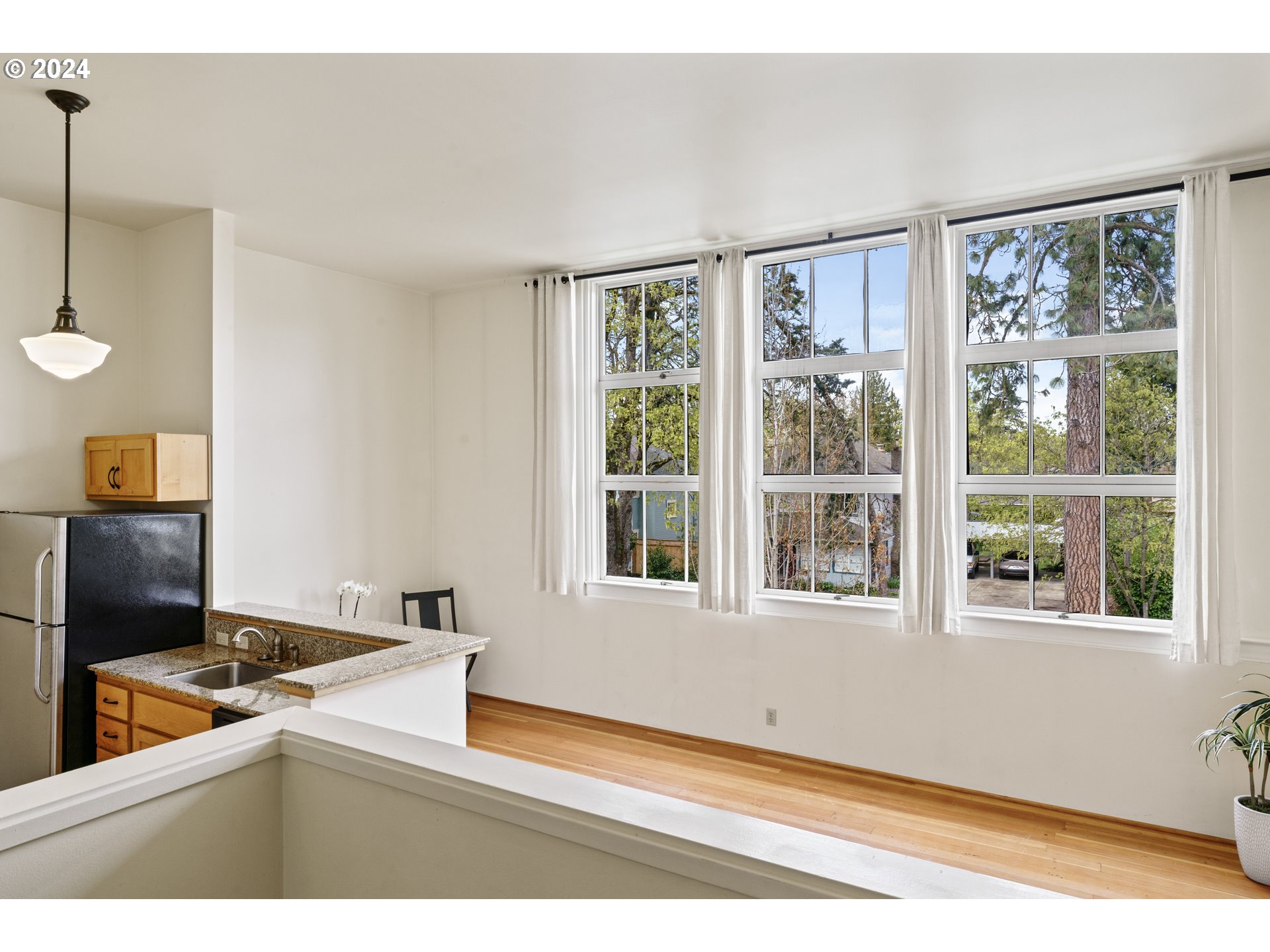 650 West 12th Avenue, Unit 202 Eugene, OR 97402 - Photo 3 of 30 a kitchen with a window wooden floor and a sink